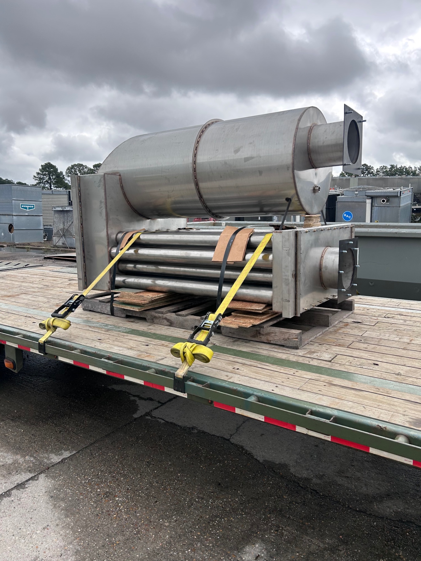Industrial equipment secured on a flatbed trailer for transport