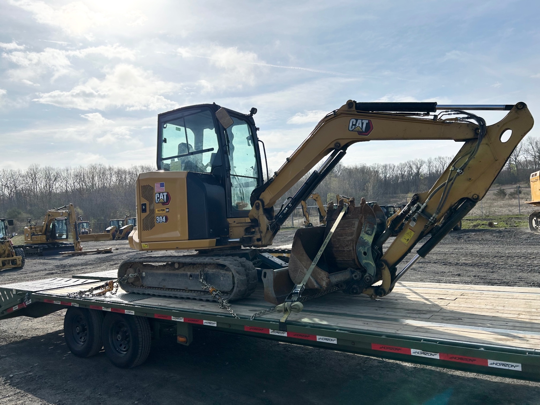 CAT 304 mini excavator chained on a BigWay flatbed