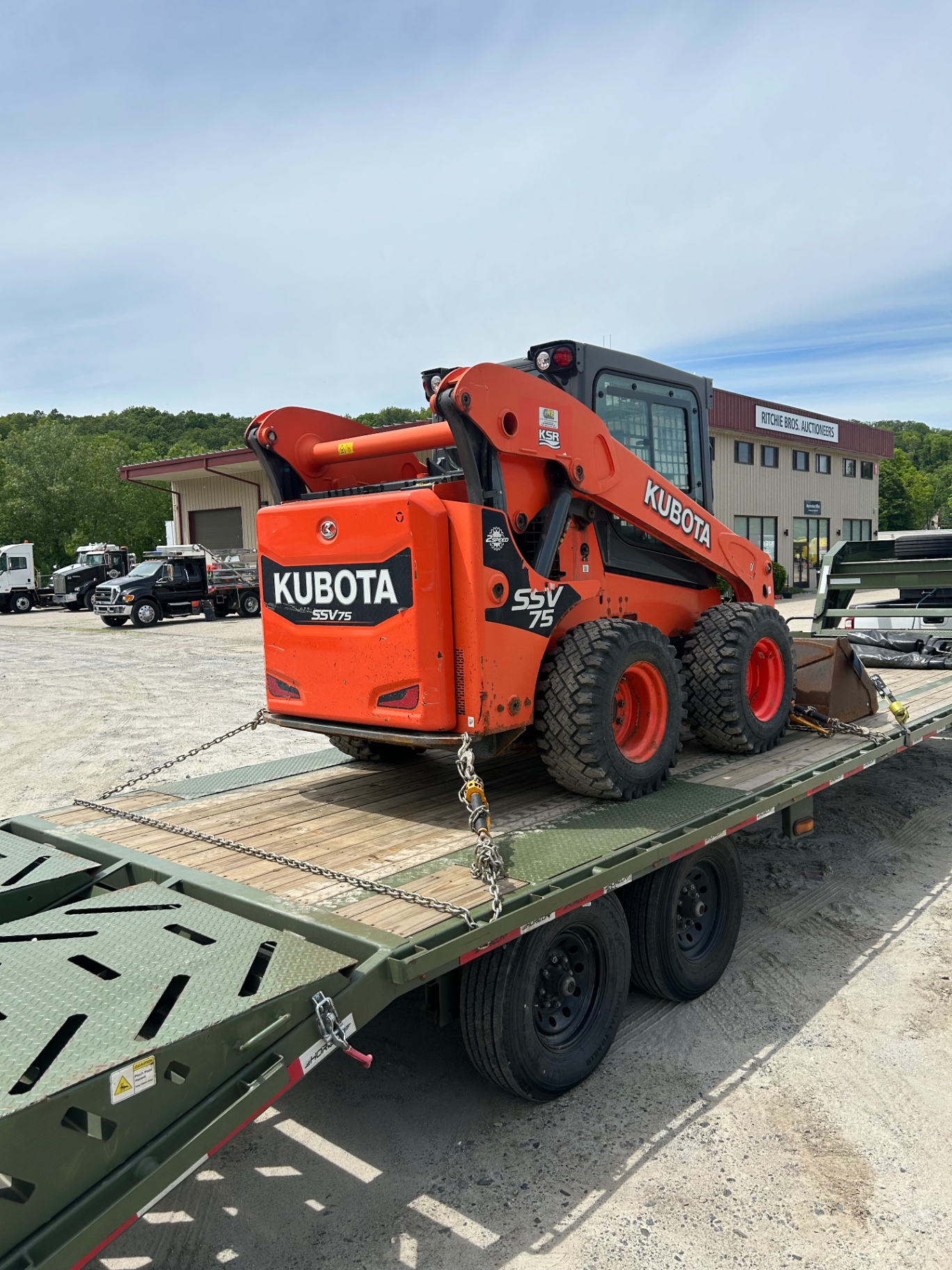 Kubota SSV75 skid steer loaded for equipment transport