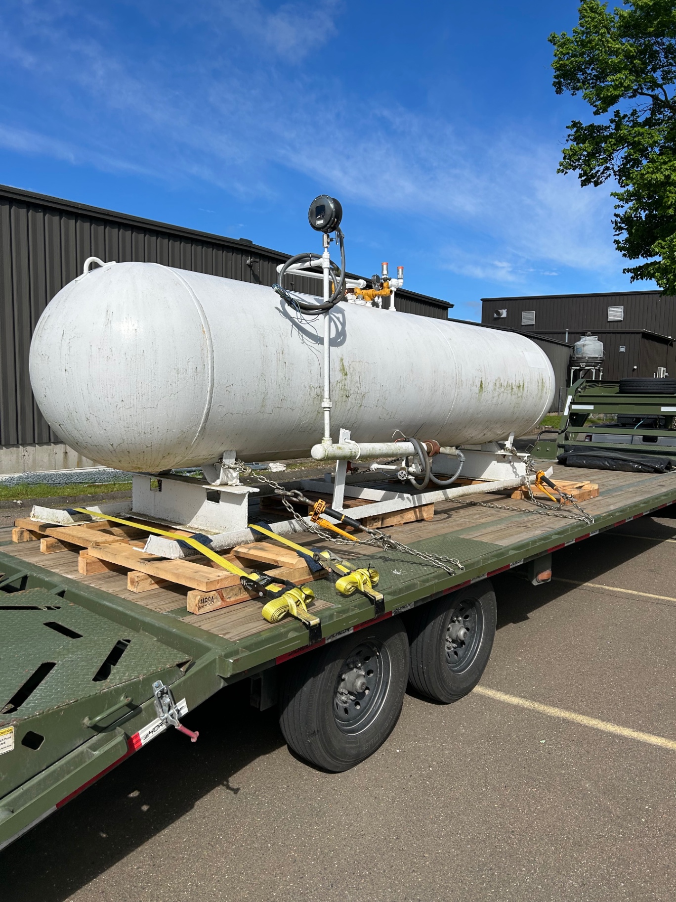 Industrial propane tank secured on a flatbed trailer